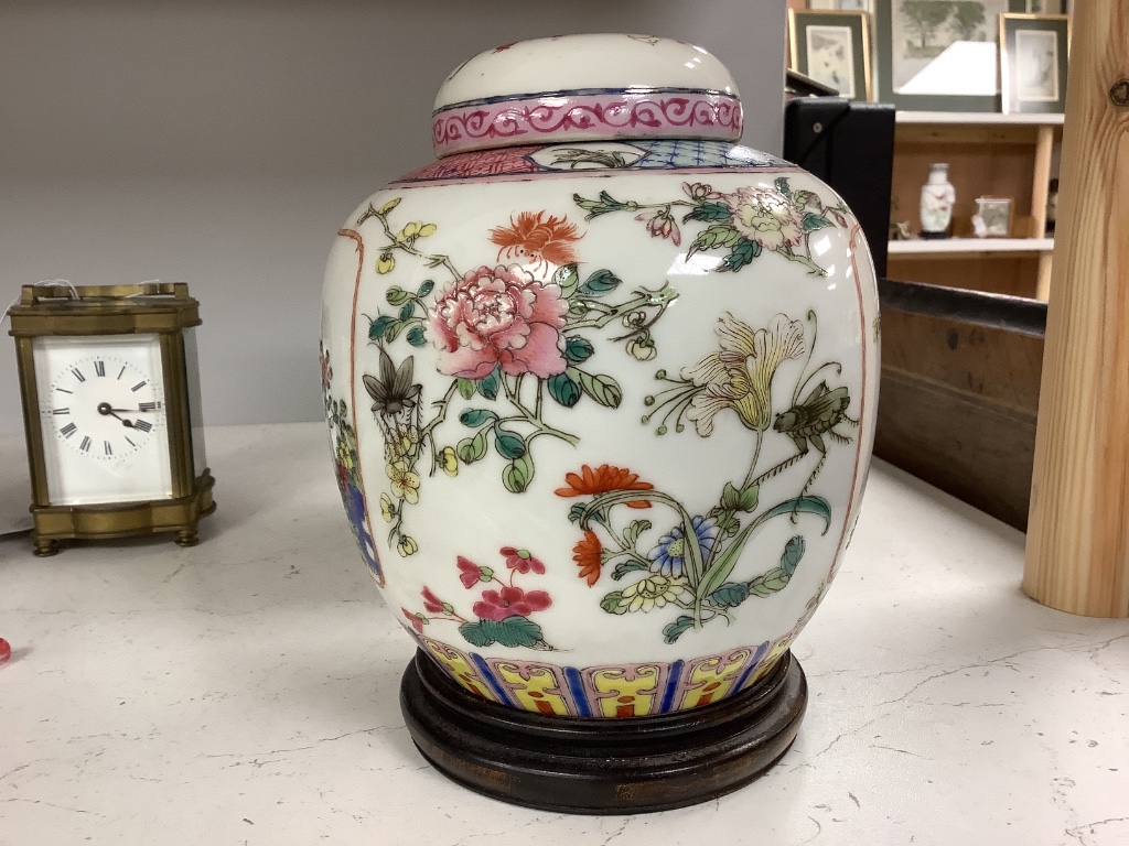 A pair of Chinese famille rose jars and covers, late 19/early 20th century, 15.5cm, on hardwood stands